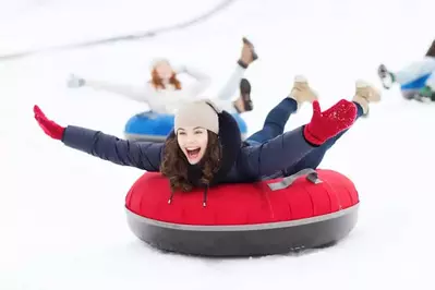 Happy girl snowtubing