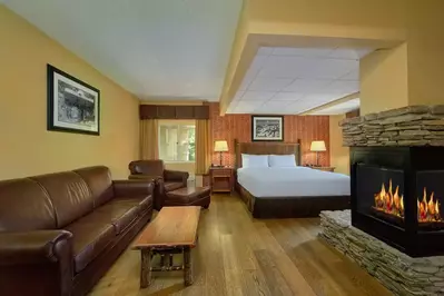 Fireplace in front of the sitting area and a bed