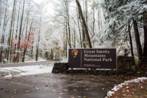 great smoky mountains national park sign covered in snow